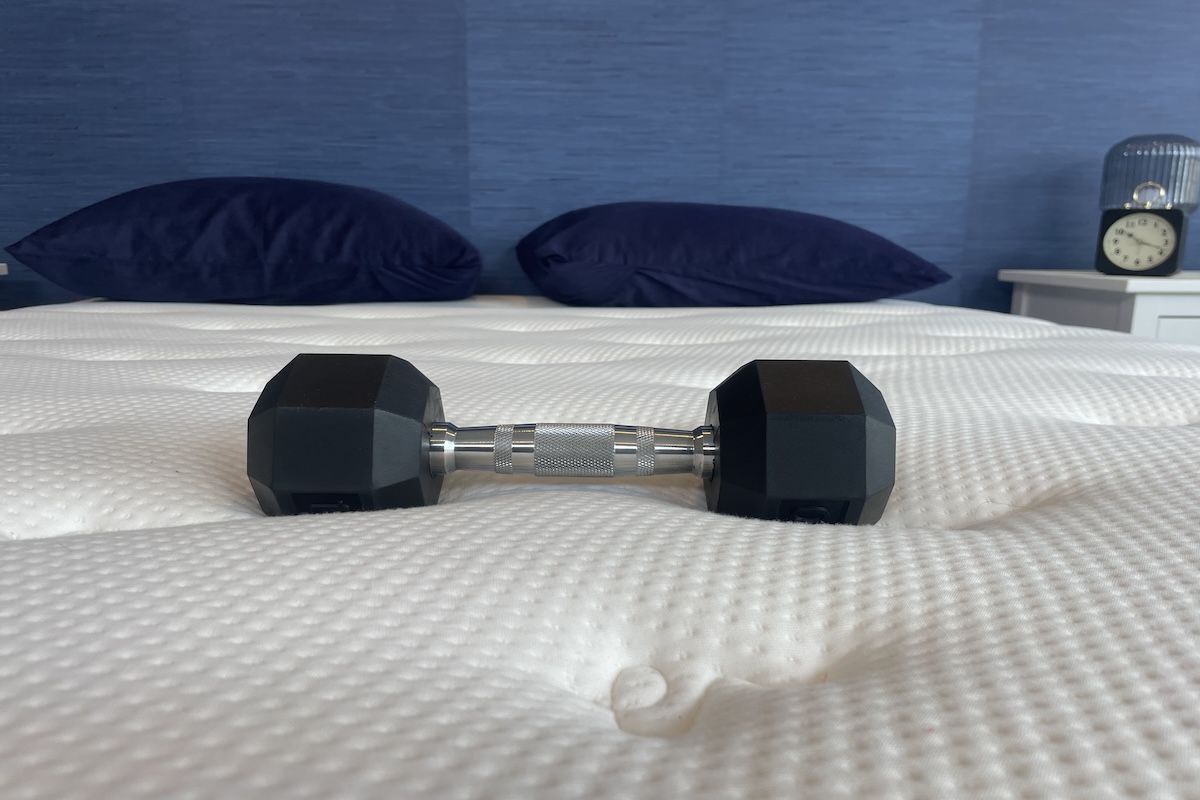 A 10-pound weight sits on top of the Brooklyn Bedding Signature Hybrid mattress in our testing facility